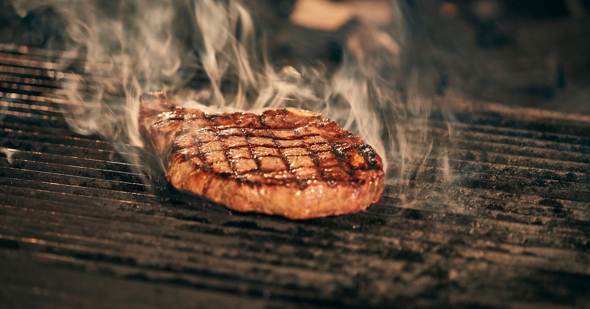Perfectly seared beef steak on a hot BBQ grill